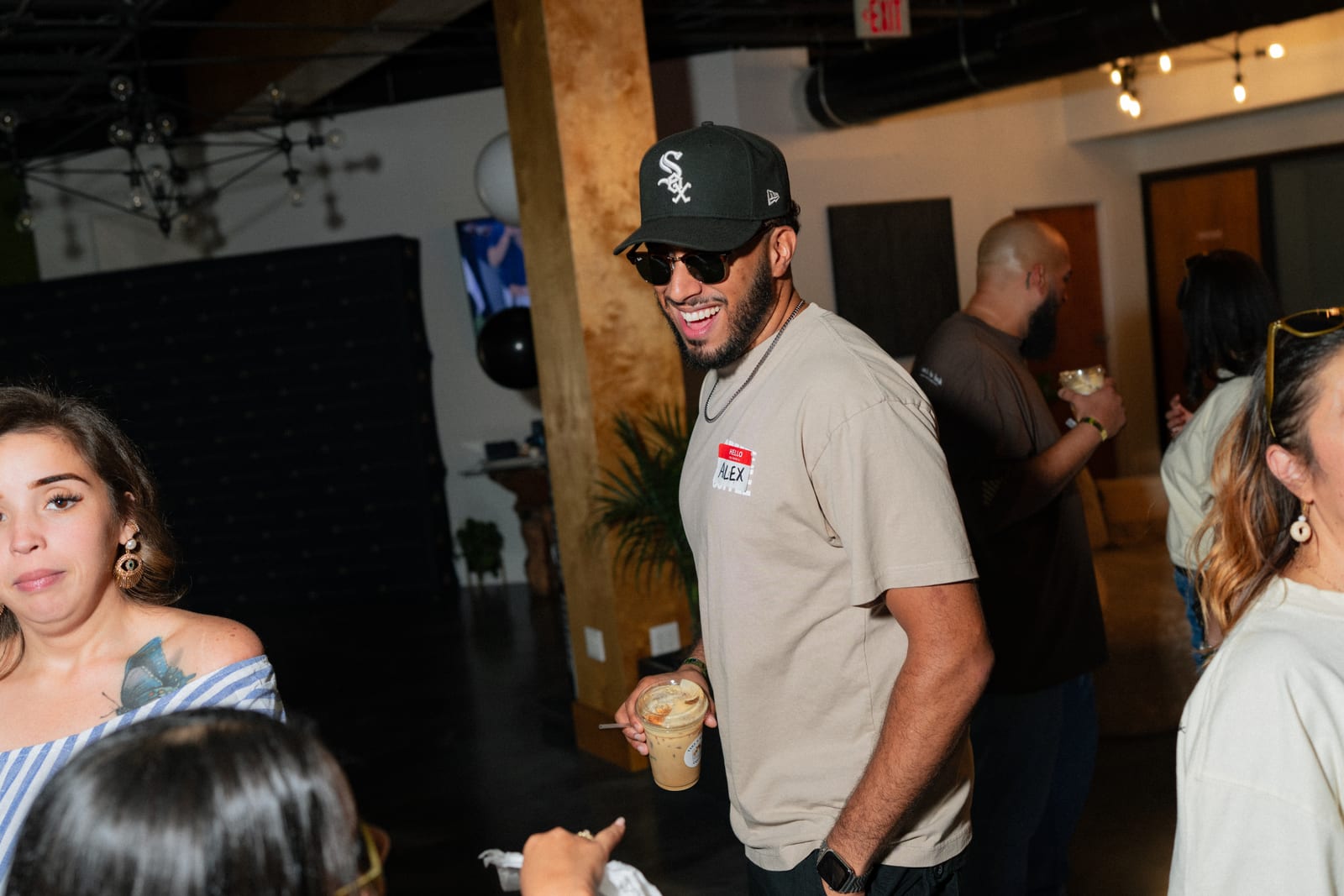 A guest in a White Sox cap dancing through the crowd