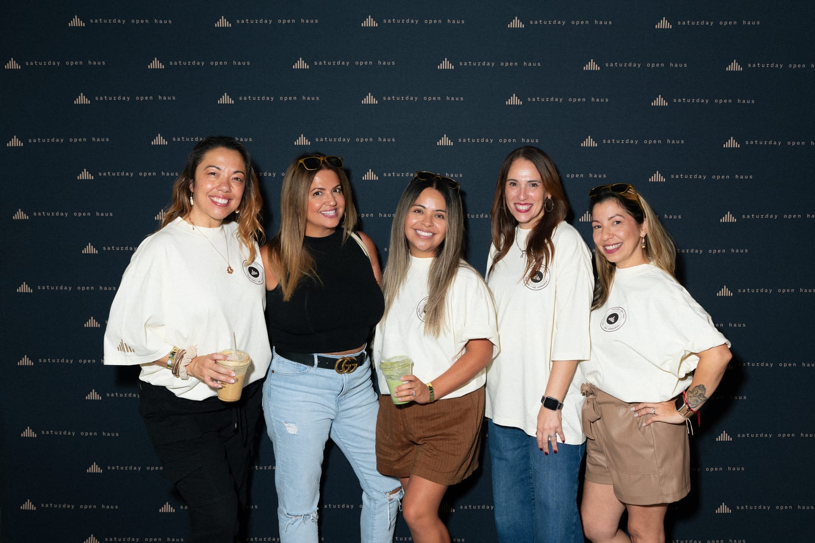 Five guests in white and espresso at the wall